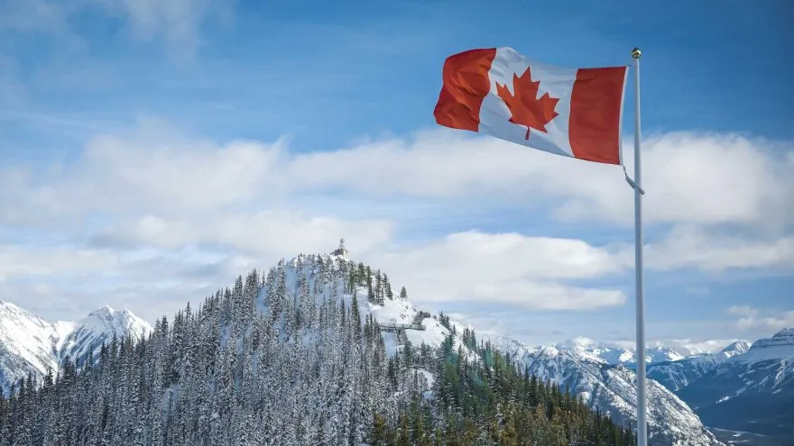 Canadian flag on a snowy mountain